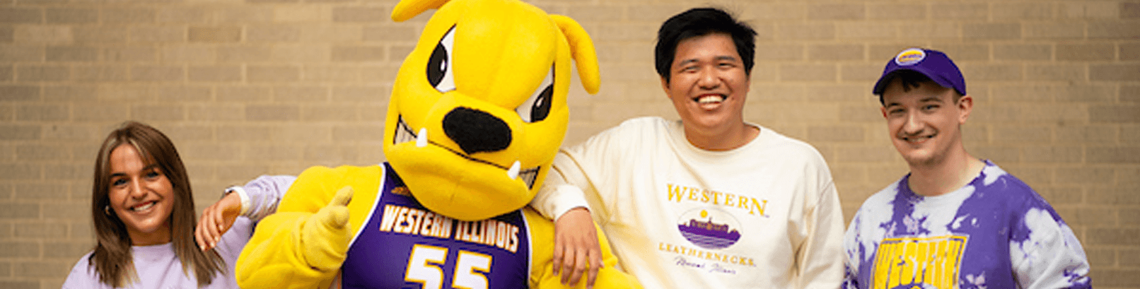 Photo of future students posing with WIU's Rocky mascot.